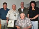 (Seated) Charles Hellman, W2RP. (L-R) Hellman’s friend Don Finkel, WA2OQM; QCWA Treasurer Charles Tropp, N2SO; and QCWA Directors Pete Varounis, NL7XM, and Carole Perry WB2MGP. [Mike Sturm, KA2E, photo]